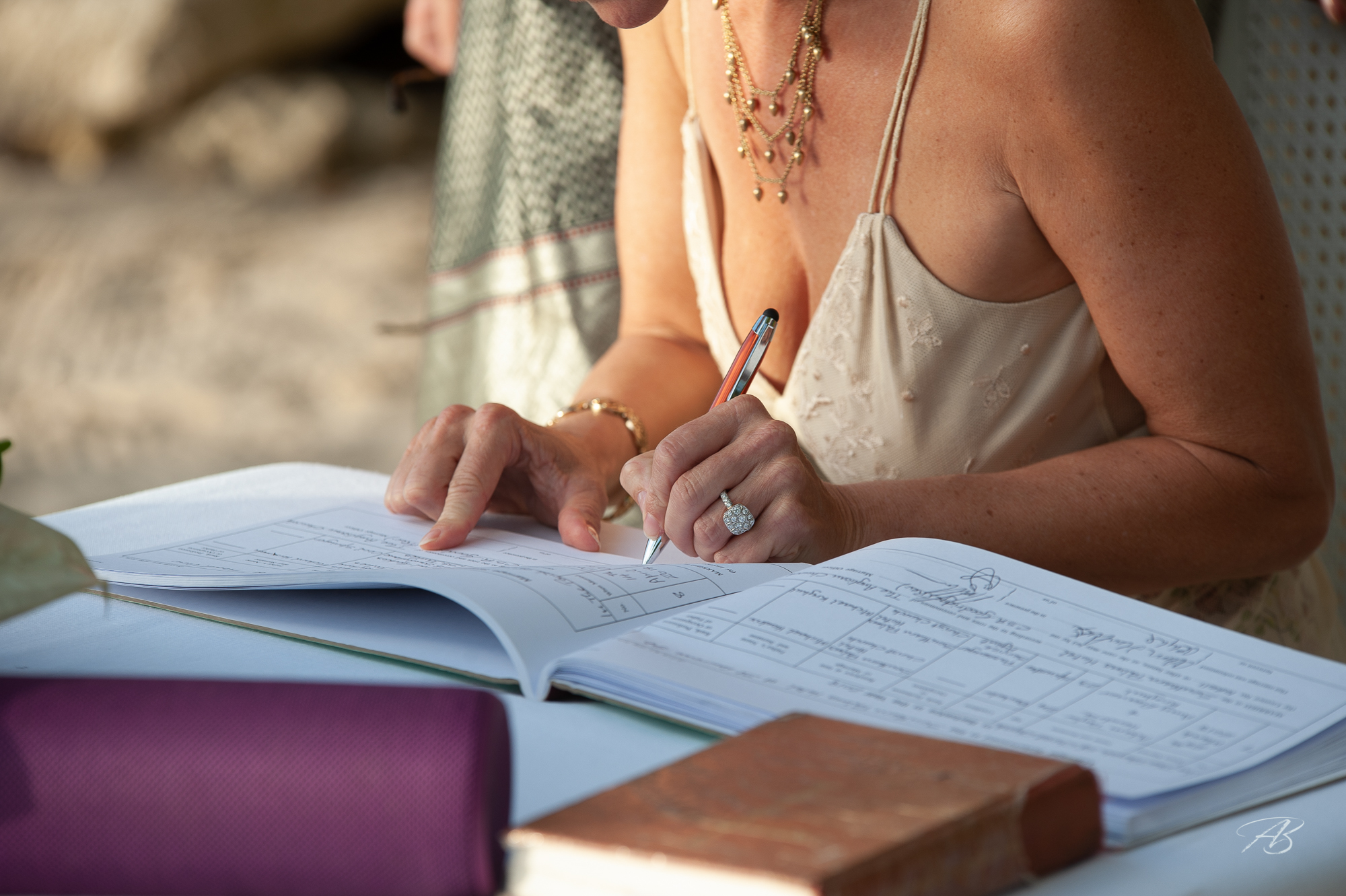 Signing the register at an intimate beach wedding